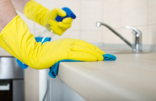 Deep cleaning a living room armchair with specialist equipment